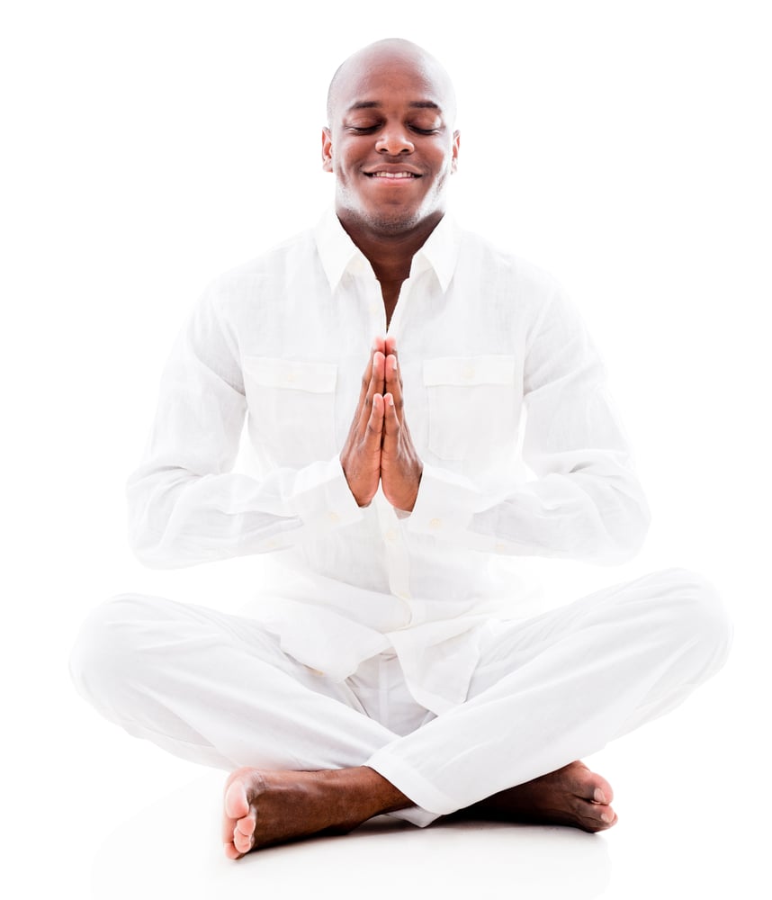 Peaceful man doing yoga exercises - isolated over a white background